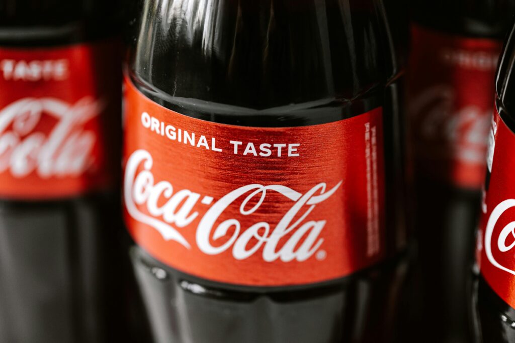High-angle shot of Coca-Cola bottles emphasizing the Original Taste label on the packaging.